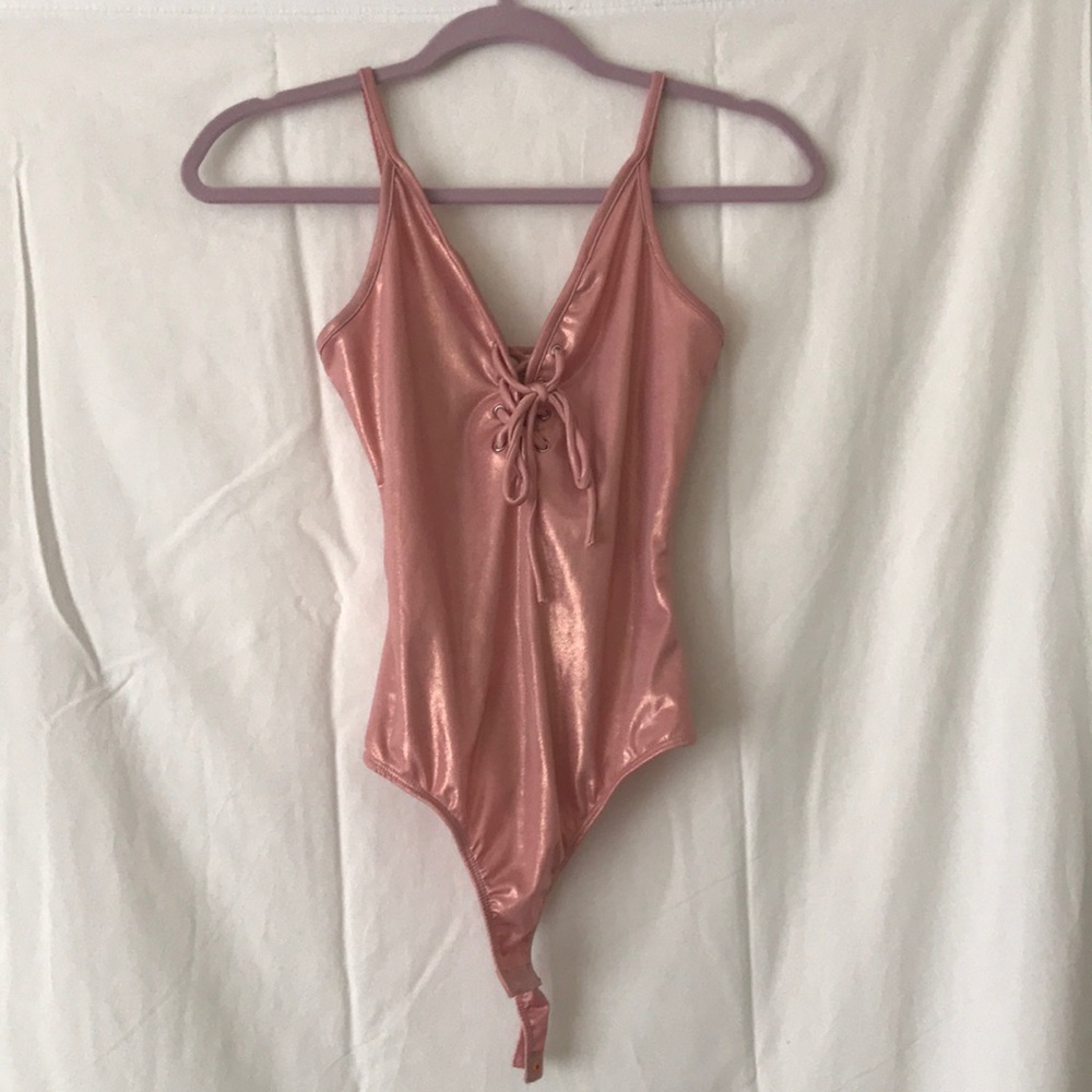 Pink, shiny, body suit.